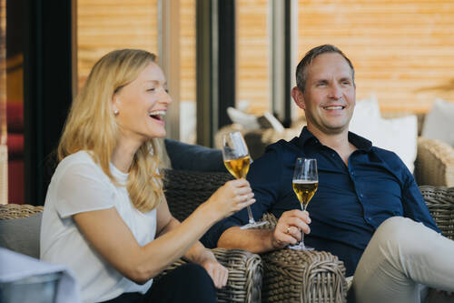 Lachendes Paar beim Aperitif in der Lounge Hotel Drei Quellen Therme